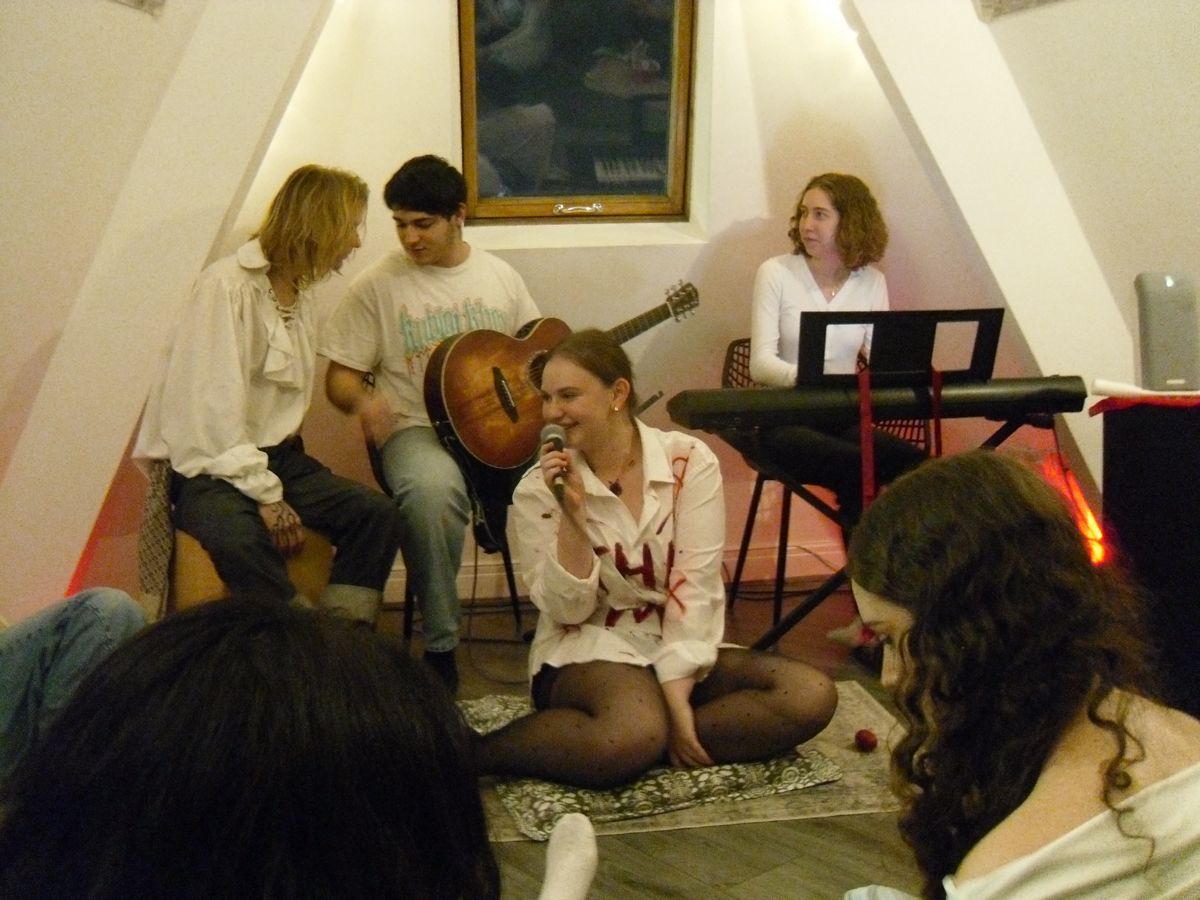 An acoustic set with guitar and keys in a small room